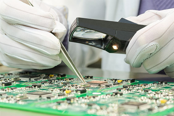 person inspecting a circuit board to deliver highest quality