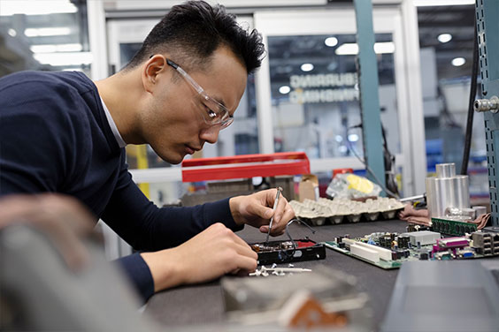 Coreworks employee working on circuit board